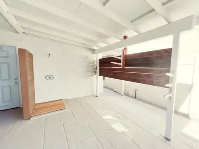 an empty room with a staircase in a house at Historical Beach Bungalow Steps Away From Sand #5 in Newport Beach