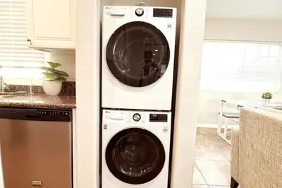 a washing machine and a dryer in a kitchen at Historical Beach Bungalow Steps Away From Sand #5 in Newport Beach