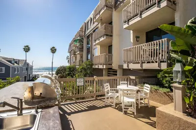 a balcony of a building with a table and chairs at Oceanside Beach Condos in Oceanside
