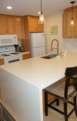 a kitchen with a white counter and a sink at Oceanside Beach Condos in Oceanside