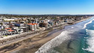 an aerial view of a beach with buildings and the ocean at Beachfront Retreat in Oceanside