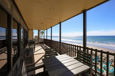 a balcony with benches and a view of the beach at Beachfront Retreat in Oceanside