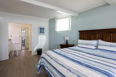 a bedroom with a large bed and a window at Beachfront Retreat in Oceanside