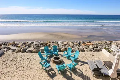 a group of chairs on a beach with the ocean at Beachfront Retreat in Oceanside