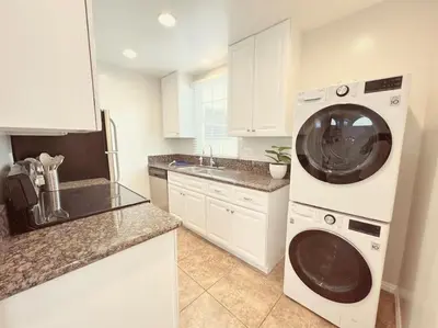 a kitchen with a washing machine and a sink at Beach Bungalow #3 in Newport Beach (A/C Included) in Newport Beach