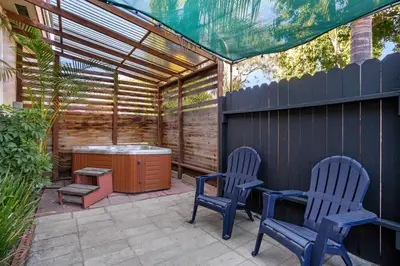 two chairs and a table on a patio at Cozy, home with hottub and patio in San Diego