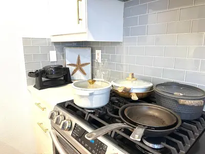 a kitchen with a stove with pots and pans on it at Comfort Retreat 3B3B Villa in Quail Hill Irvine in Irvine