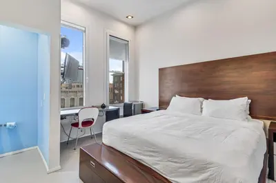 a bedroom with a large bed and a desk with a chair at The Keating in San Diego