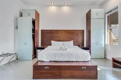 a bedroom with a large bed with a wooden headboard at The Keating in San Diego