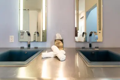 a bathroom with two sinks and towels on a counter at The Keating in San Diego