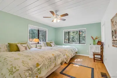 a bedroom with two beds and a ceiling fan at The Bungalow Partial Home Rental in Julian