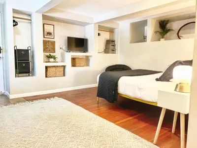 a bedroom with a bed and a tv on the wall at Urban Oasis near the Zoo A Central Studio for 2 in San Diego