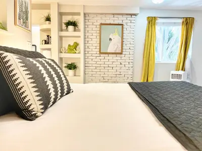 a bedroom with a bed and a brick wall at Urban Oasis near the Zoo A Central Studio for 2 in San Diego