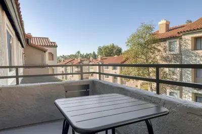 a table on a balcony with a view of buildings at Rancho Penasquitos 1br w pool gym nr bars SAN-31 in San Diego