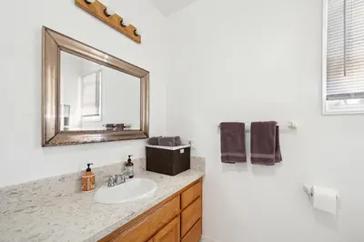 a bathroom with a sink and a mirror at Coastal Haven in Oceanside- Cozy Beach Getaway home in Oceanside