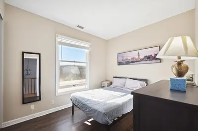 a bedroom with a bed and a window at Coastal Haven in Oceanside- Cozy Beach Getaway home in Oceanside