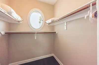 a walk in closet with shelves and a round window at Coastal Haven in Oceanside- Cozy Beach Getaway home in Oceanside
