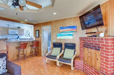a living room with two chairs and a fireplace at Downtown Carlsbad Apartment Less Than half Mi to Beach! in Carlsbad