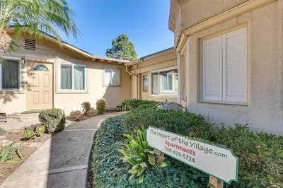 a house with a sign in front of it at Downtown Carlsbad Apartment Less Than half Mi to Beach! in Carlsbad