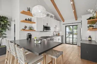 a kitchen with a black counter top in a room at Neptune Hidden Gem in Encinitas