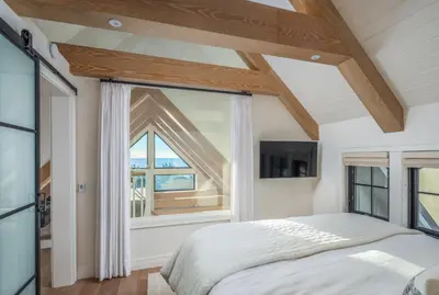 a bedroom with a bed and a large window at Neptune Ocean View Masterpiece in Encinitas