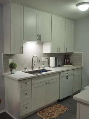 a kitchen with white cabinets and a sink at Charming 1Bedroom Vacation Condo in Oceanside