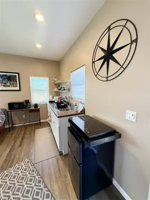a kitchen with a large clock on the wall at The studio apartment in Clairemont - New AC unit in San Diego
