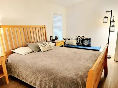 a bedroom with a large bed with a wooden headboard at The Blue Cove in Hemet