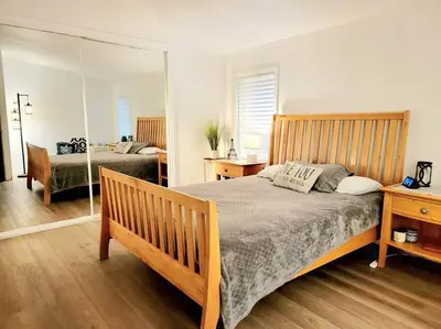 a bedroom with a large bed and a mirror at The Blue Cove in Hemet