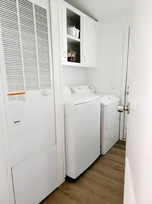 a laundry room with white appliances and a white door at The Blue Cove in Hemet
