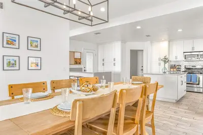 a dining room and kitchen with a table and chairs at Villa Descanso in Oceanside