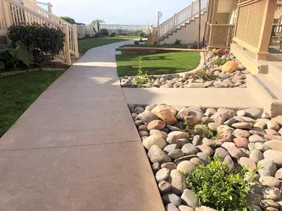 a walkway in front of a house with rocks at Casa De La Playa in San Diego