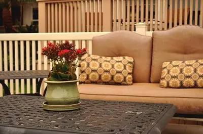 a vase with flowers on a table in front of a couch at Casa De La Playa in San Diego