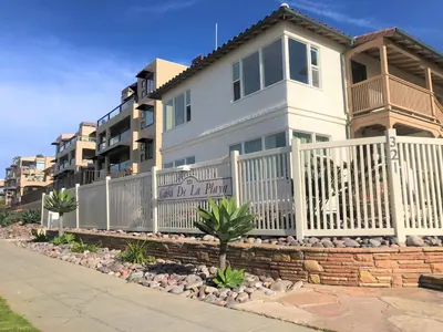 a house with a white fence in front of it at Casa De La Playa in San Diego