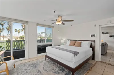 a bedroom with a bed and a large window at Belmont Ocean Views - Massive Private Deck, Grill & Parking in San Diego