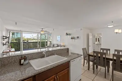 a kitchen with a sink and a table with chairs at Belmont Ocean Views - Massive Private Deck, Grill & Parking in San Diego