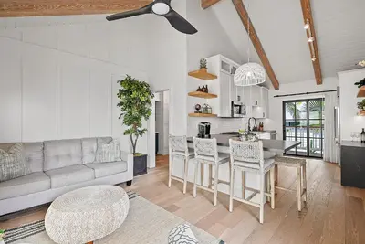 a living room with a couch and a table at Neptune Experience in Encinitas