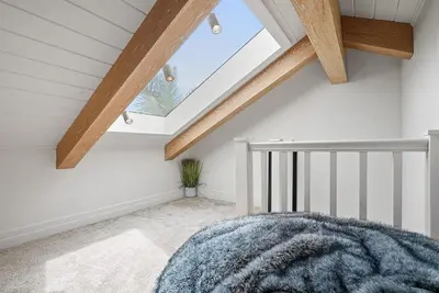 a attic room with a skylight at Neptune Experience in Encinitas