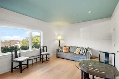 a living room with a couch and a glass table at Coastal La Jolla Luxury - AC & Large Ocean View Patio! in San Diego