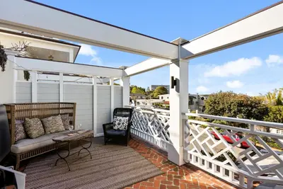 a white pergola on a balcony with a couch at Coastal La Jolla Luxury - AC & Large Ocean View Patio! in San Diego