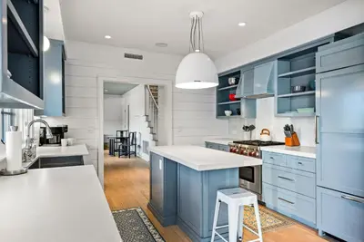 a kitchen with blue cabinets and white countertops at Coastal La Jolla Luxury - AC & Large Ocean View Patio! in San Diego