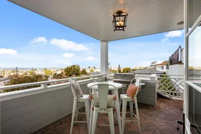 a patio with a table and chairs on a balcony at Cabrillo Villa - Massive 7br La Jolla Estate in San Diego