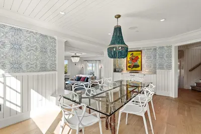 a dining room with a glass table and white chairs at Cabrillo Villa - Massive 7br La Jolla Estate in San Diego