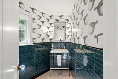 a bathroom with blue tiled walls and a mirror at Cabrillo Villa - Massive 7br La Jolla Estate in San Diego