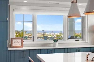 a kitchen with a window with a view of the ocean at Cabrillo Villa - Massive 7br La Jolla Estate in San Diego