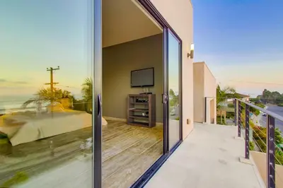 a balcony with a view of the ocean from a house at Sunset Cliffs Modern Luxury Estate w Ocean Views, Oversized Spa, AC, Yard! in San Diego