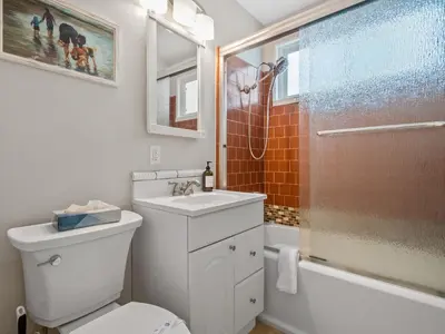 a bathroom with a toilet and a sink and a shower at Stunning beach home - steps2sand, AC, Large Patio and Fast Wifi! in San Diego