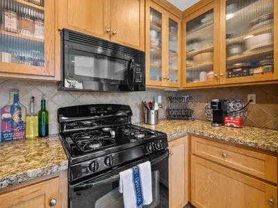 a kitchen with a black stove and a microwave at Pacific Beach Paradise - Near the Beach w AC, Garage, Fast Wifi & Private Patio! in San Diego