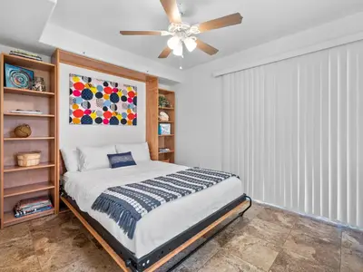 a bedroom with a bed and a ceiling fan at Pacific Beach Paradise - Near the Beach w AC, Garage, Fast Wifi & Private Patio! in San Diego