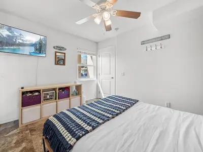 a bedroom with a bed and a ceiling fan at Pacific Beach Paradise - Near the Beach w AC, Garage, Fast Wifi & Private Patio! in San Diego